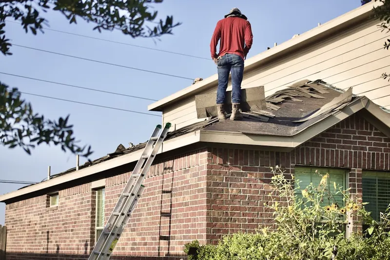 Professional roofer working on a residential roof in University Woods